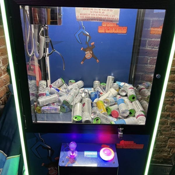 A claw machine filled with various empty beverage cans, including White Claw, at Swanky's Vittles and Libations.